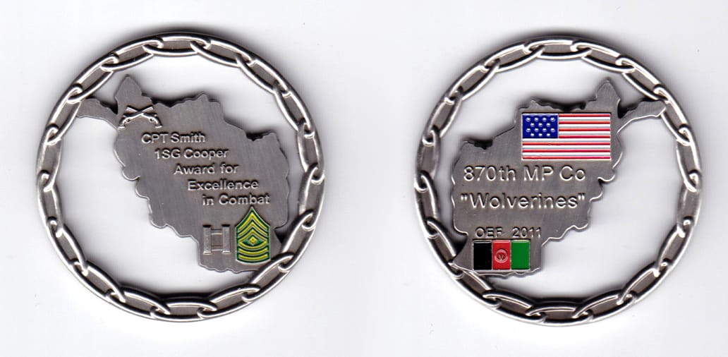 Round shaped, pewter colored coin, 2 inches in diameter.