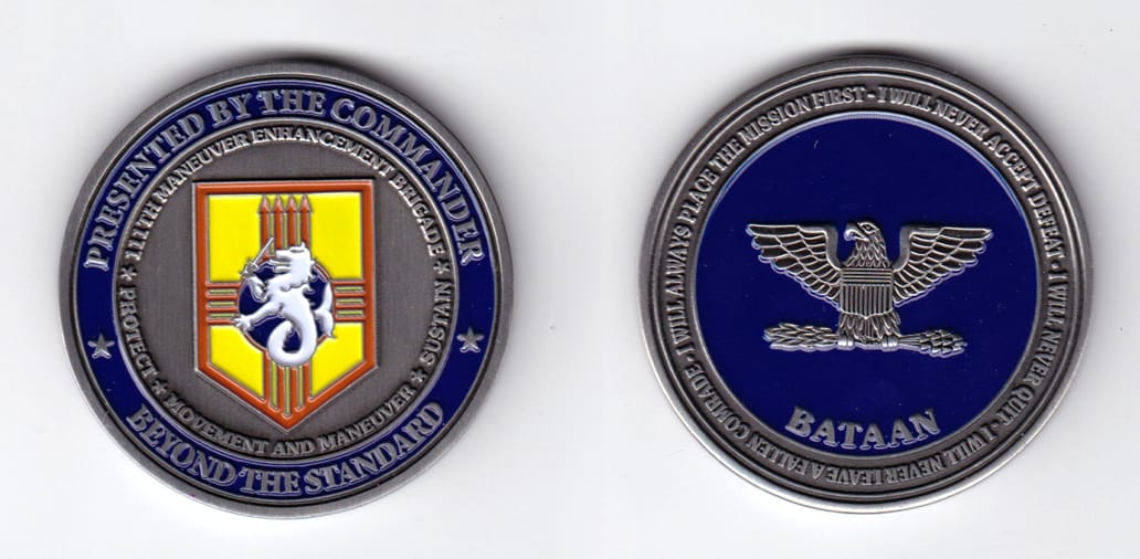 Round shaped, pewter colored coin, 2 inches in diameter.