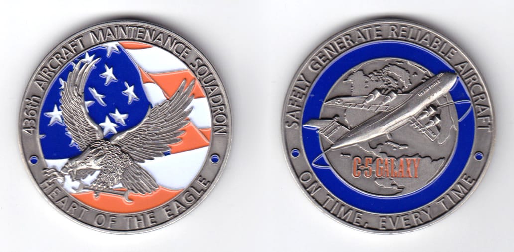 Round shaped, pewter colored coin, 2 inches in diameter.