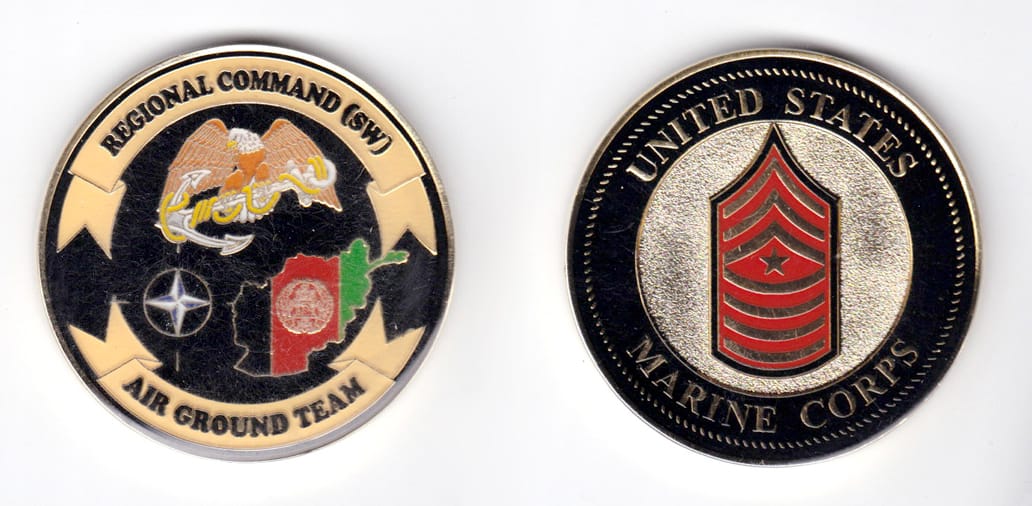 Round shaped, gold colored coin, 2 inches in diameter.