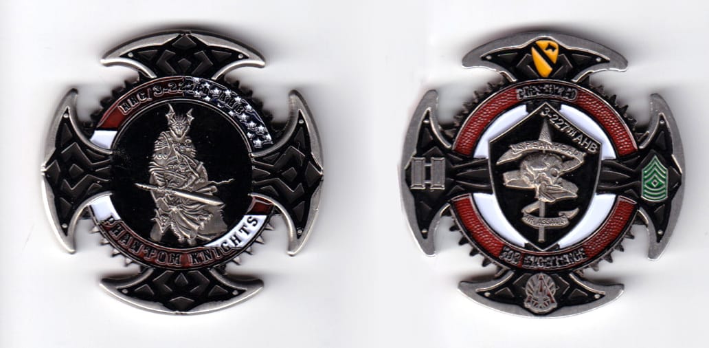 Round shaped with cut out areas around, pewter colored coin, 2 inches in diameter.