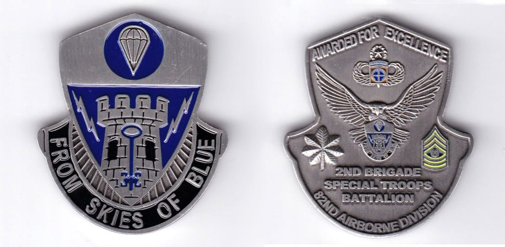 Shield shaped, with banner mounted beneath, pewter colored coin, 1-3/4 inches wide x  2 inches high.