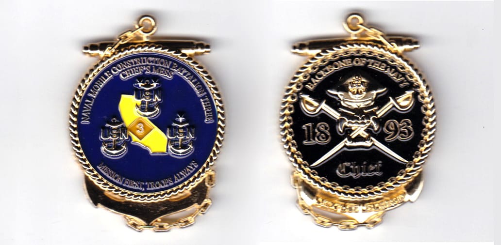 Anchor with circle mounted on top shaped, gold colored coin, 1-1/2 inches wide x  2 inches high.