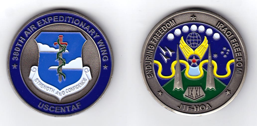 Round shaped, pewter colored coin, 2 inches in diameter.