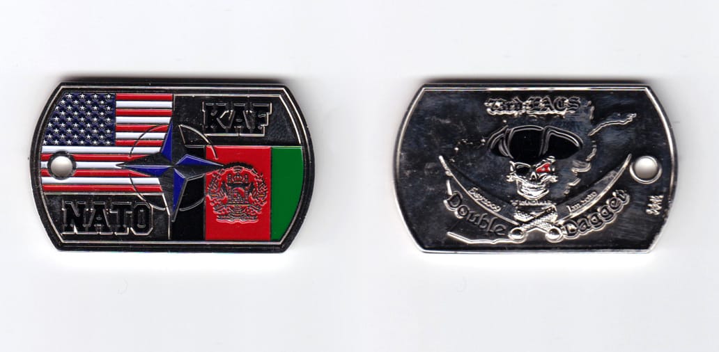 Dog tag shaped, silver colored coin, 2 inches wide x  1-3/16 inches high.