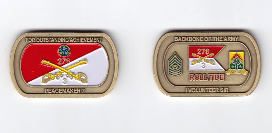 Dog tag shaped, brass colored coin, 2 inches wide x  1-3/16 inches high.