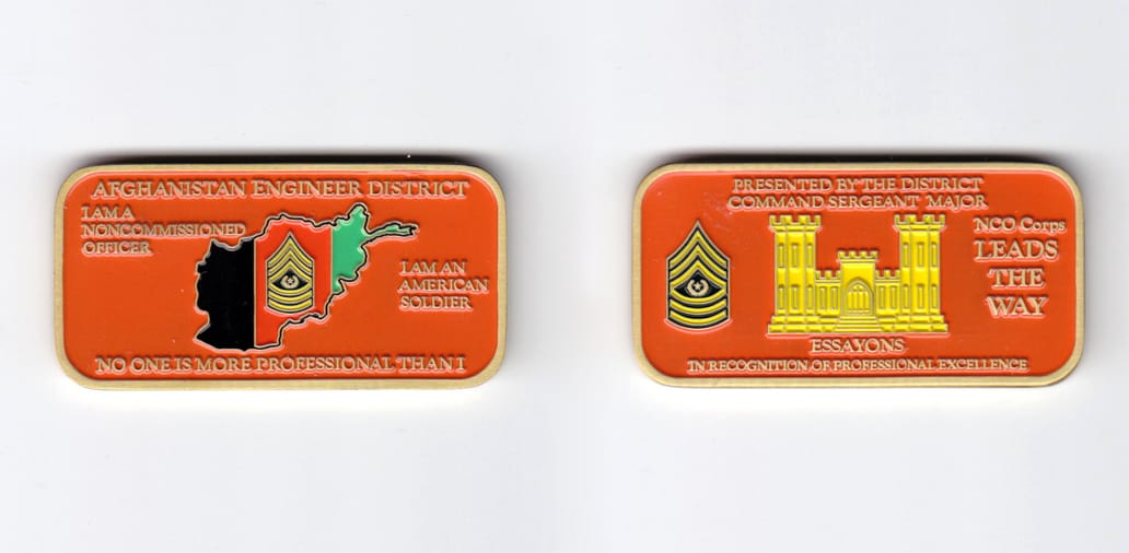 Retangular shaped, brass colored coin, 2-3/8 inches wide x  1-3/16 inches high.