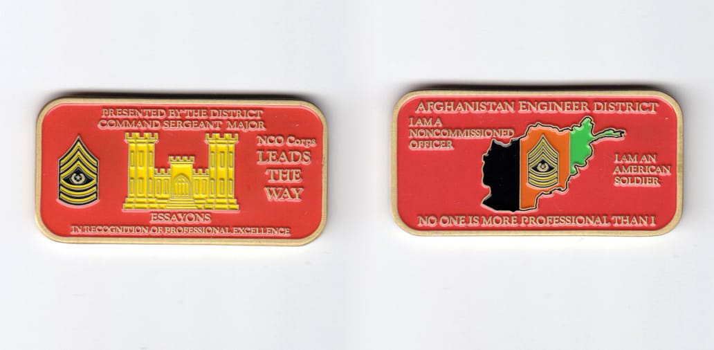 Retangular shaped, brass colored coin, 2-3/8 inches wide x  1-3/16 inches high.