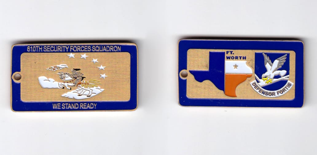 Retangular shaped, brass colored coin, 2 inches wide x  1-1/16 inches high.