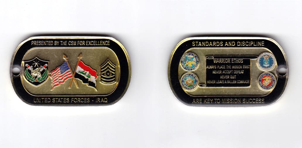 Dog tag shaped, brass colored coin, 2-1/8 inches wide x  1-1/4 inches high.