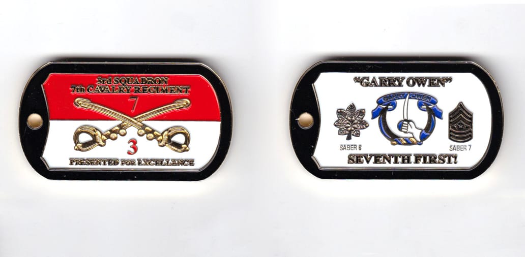 Dog tag shaped, brass colored coin, 2-1/4 inches wide x  1-1/4 inches high.