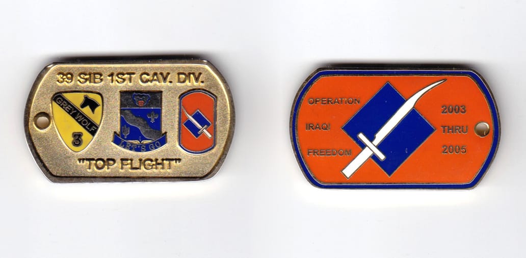 Dog tag shaped, gold colored coin, 2 inches wide x  1-3/16 inches high.