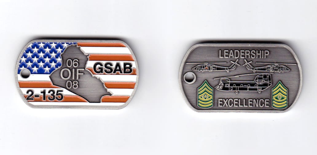 Dog tag shaped, pewter colored coin, 2 inches wide x  1-1/8 inches high.