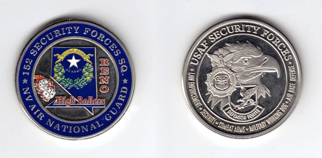 Round shaped, silver colored coin, 1-1/2 inches in diameter.