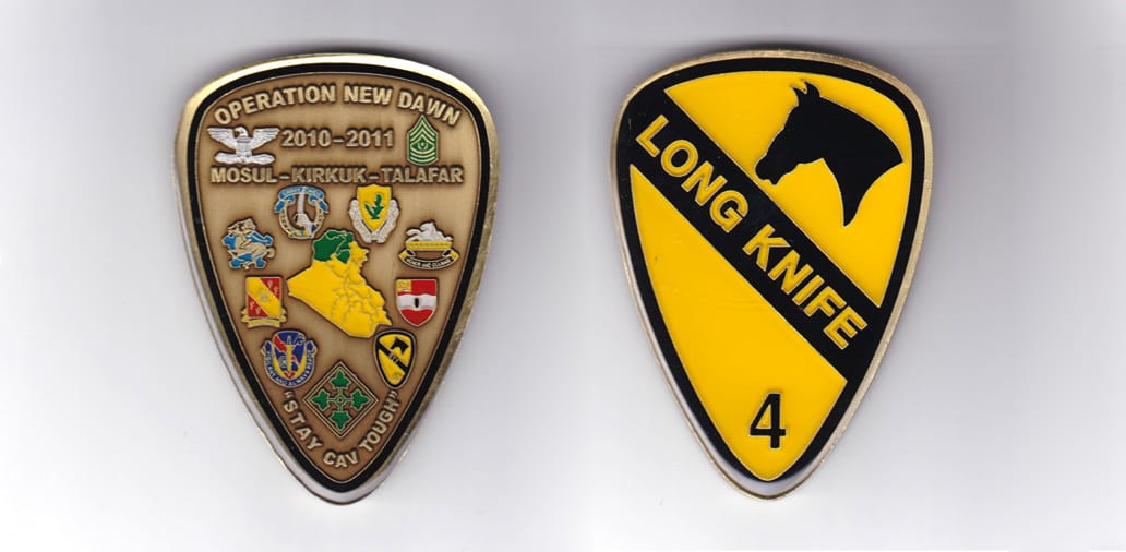 Shield shaped, antique brass colored coin, 2 inches wide x 3-1/16 inches high.