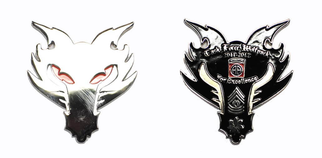 Wolf's head shaped, silver colored coin, 3 inches wide x 2-1/2 inches high.