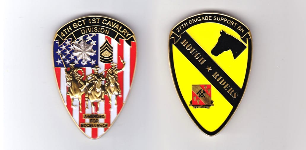 Shield shaped, gold colored coin, 1-1/2 inches wide x 2-1/2 inches high.