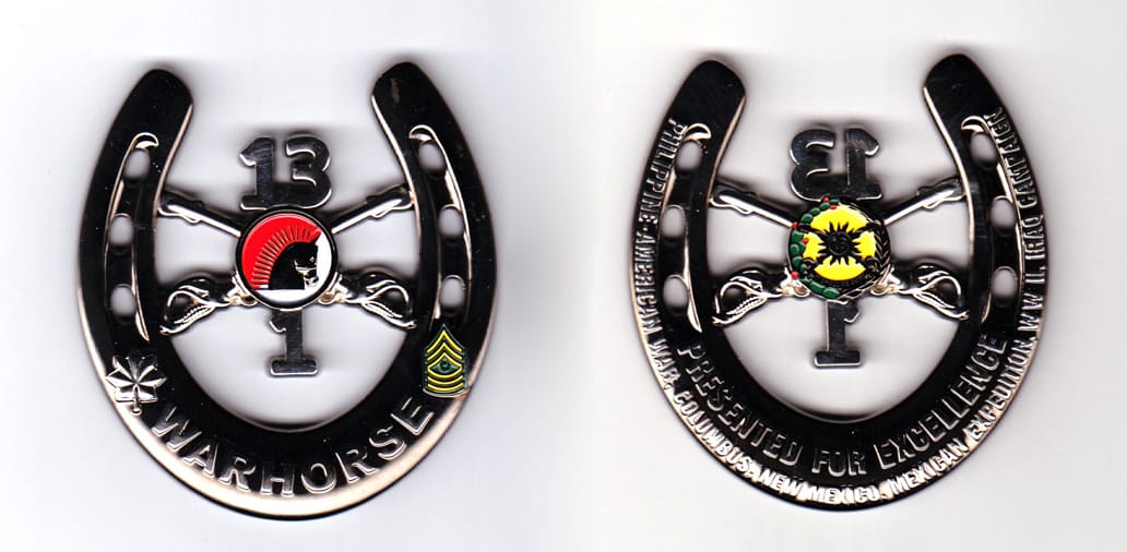 Horseshoe shaped with crossed sabers, circle and numbers mounted in center, silver colored coin, 2-1/4 inches wide x  2-...