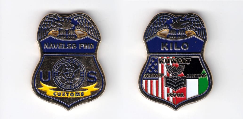 Shield shaped, gold colored coin 1-3/8 inches wide x 1-3/4 inches high.