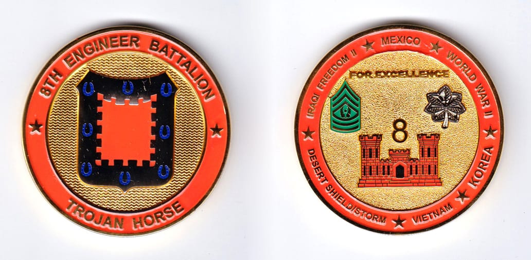 Round shaped, gold colored coin, 2 inches in diameter.