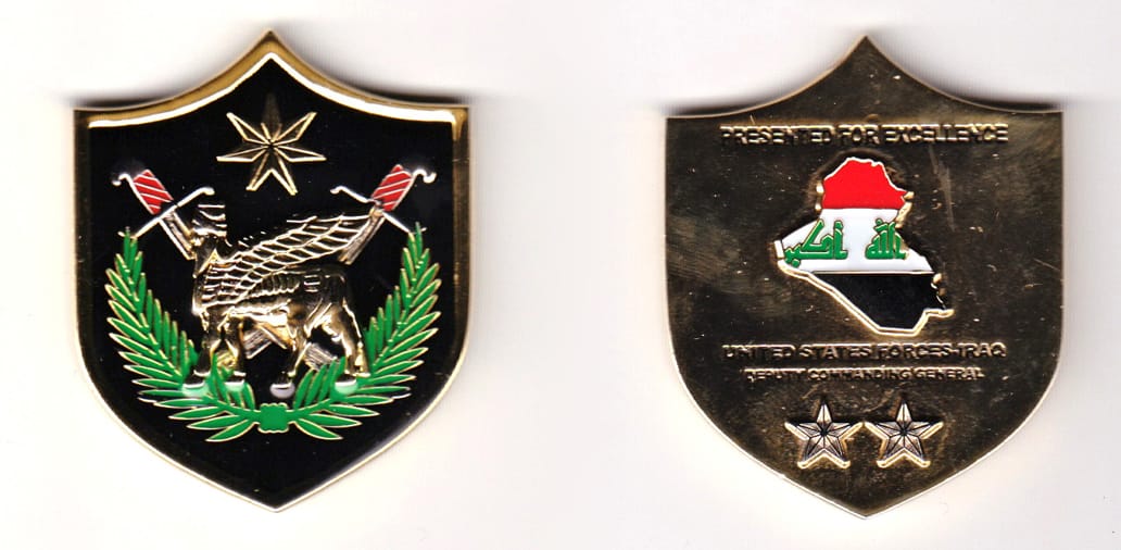 Shield shaped, gold colored coin, 1-3/4 inches wide x 2 inches high.