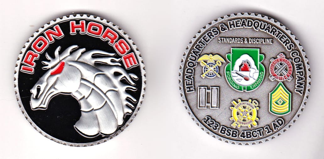 Round shaped, pewter colored coin, 2 inches in diameter.