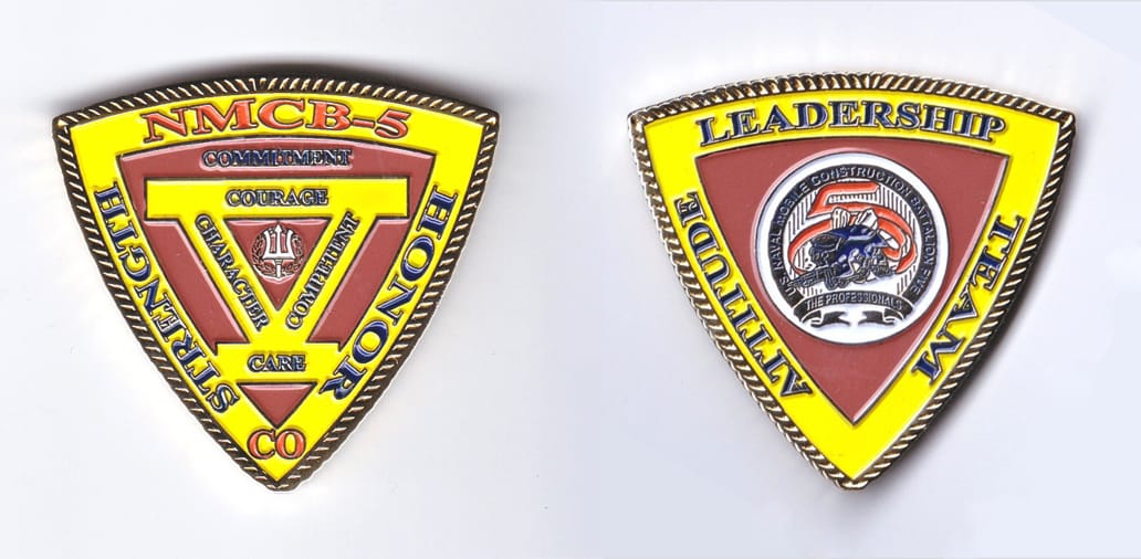 Triangular shaped, gold colored coin, 2 inches wide x 2 inches high.