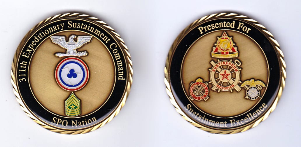 Round shaped, gold colored coin, 2 inches in diameter.