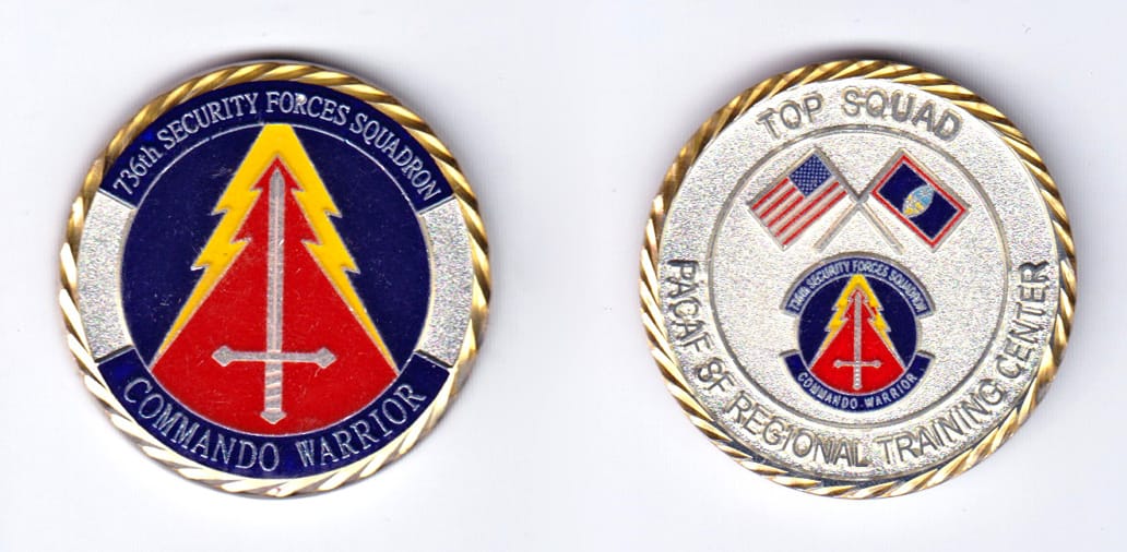 Round shaped, gold colored coin, 1-3/4 inches in diameter.