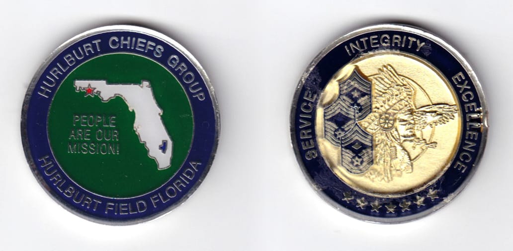 Round shaped, silver colored coin, 1-9/16 inches in diameter.