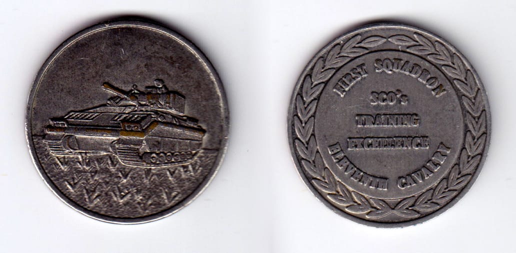 Round shaped, pewter colored coin, 1-5/8 inches in diameter.