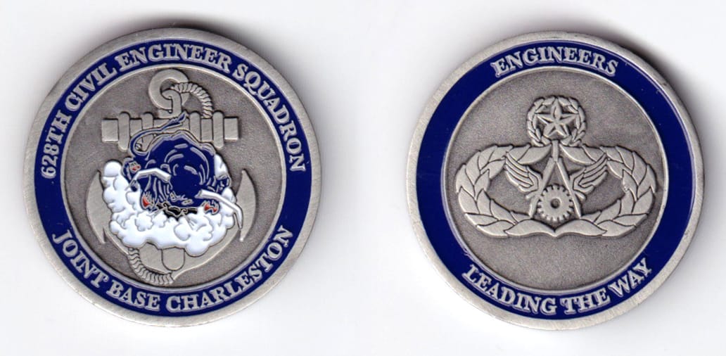 Round shaped, pewter colored coin, 1-1/2 inches in diameter.