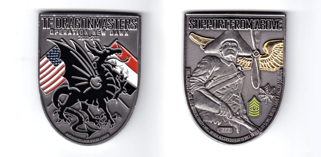 Shield shaped, pewter colored coin, 2 inches wide x 2-1/2 inches high.