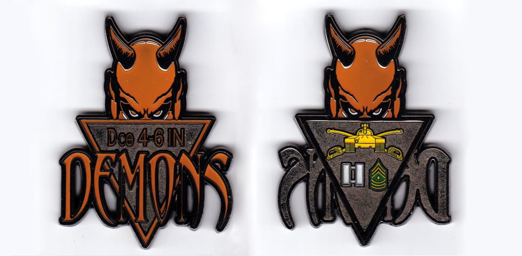 Shield shaped, silver colored coin, 2-1/4 inches wide x 3 inches high.