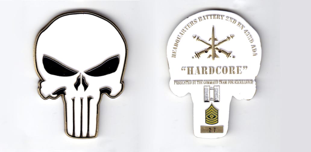 Skull shaped, brass colored coin, 2 inches wide x 2-5/8 inches high.