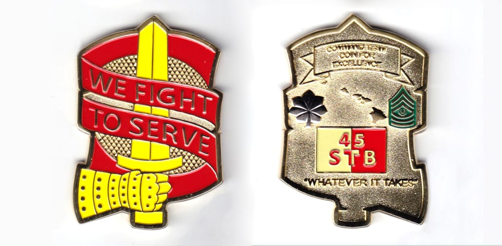 Hand and sword rampent surrounded by banners, gold colored coin, 2 inches wide x 2-3/4 inches high.