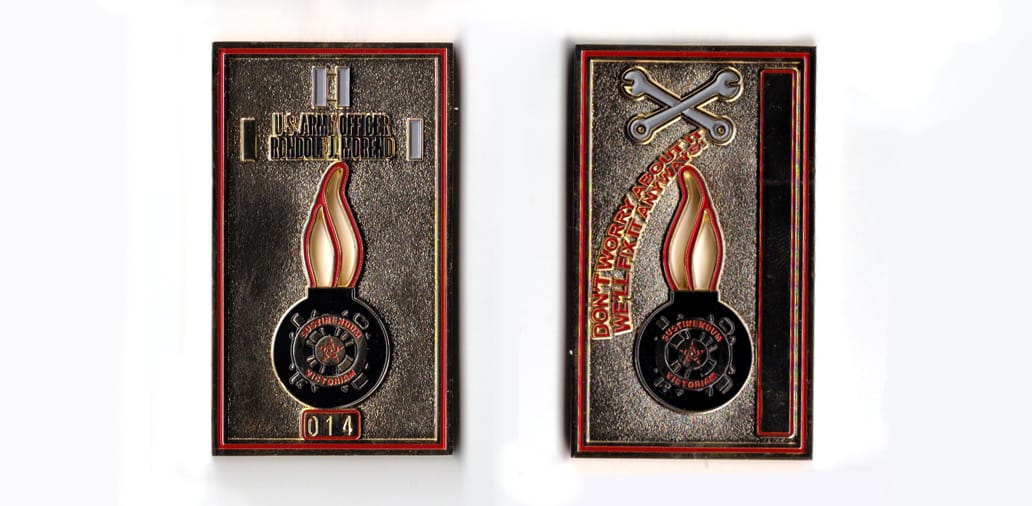 Rectangular shaped, gold colored coin, 1-15/16 inches wide x 2-1/2 inches high.