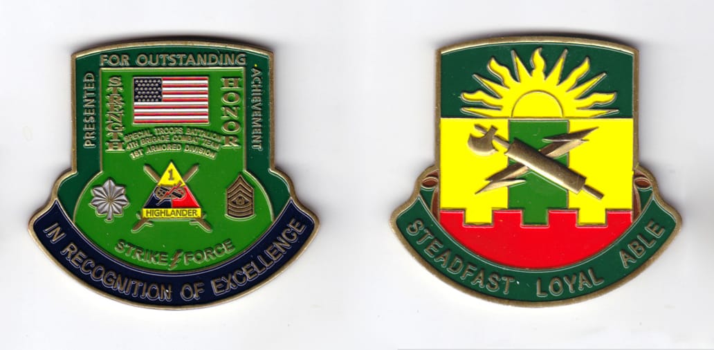 Shield shaped with banner mounted beneath, brass colored coin, 2-1/4 inches wide x 2-1/2 inches high.