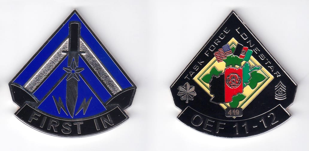 Triangle shaped, with banner mounted beneath, silver colored coin, 2-1/2 inches wide x 2-1/2 inches high.