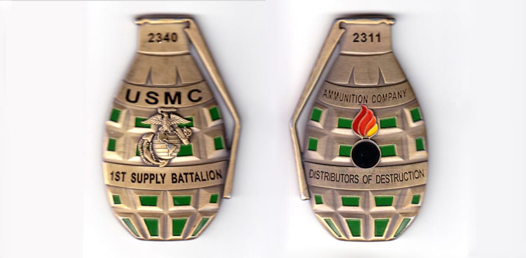 Grenade shaped, antique brass colored coin, 1-1/2 inches wide x 2-1/2 inches high.