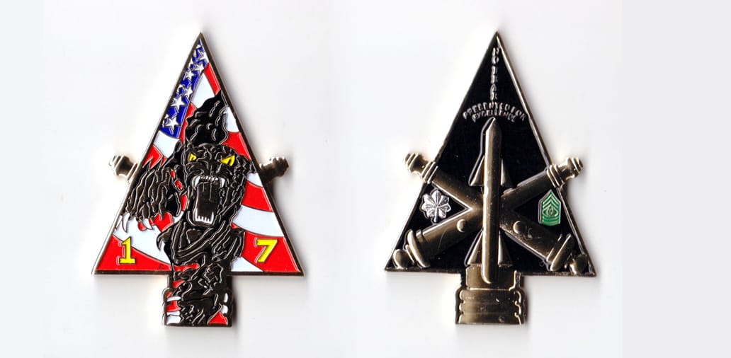 Arrow shaped, gold colored coin, 1-3/4 inches wide x 2-1/2 inches high.