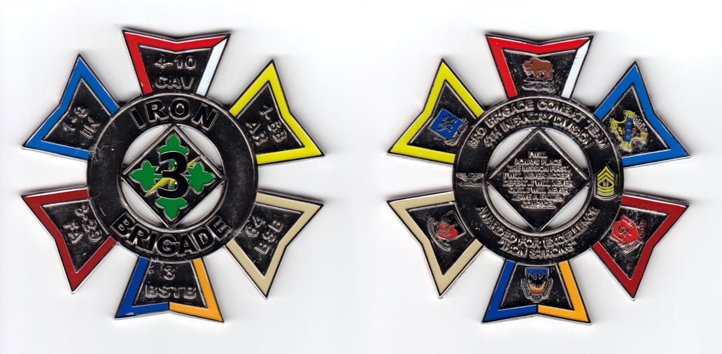 Round shaped with six tabs extending, silver colored coin, 3-1/2 inches wide x 3-1/4 inches high.