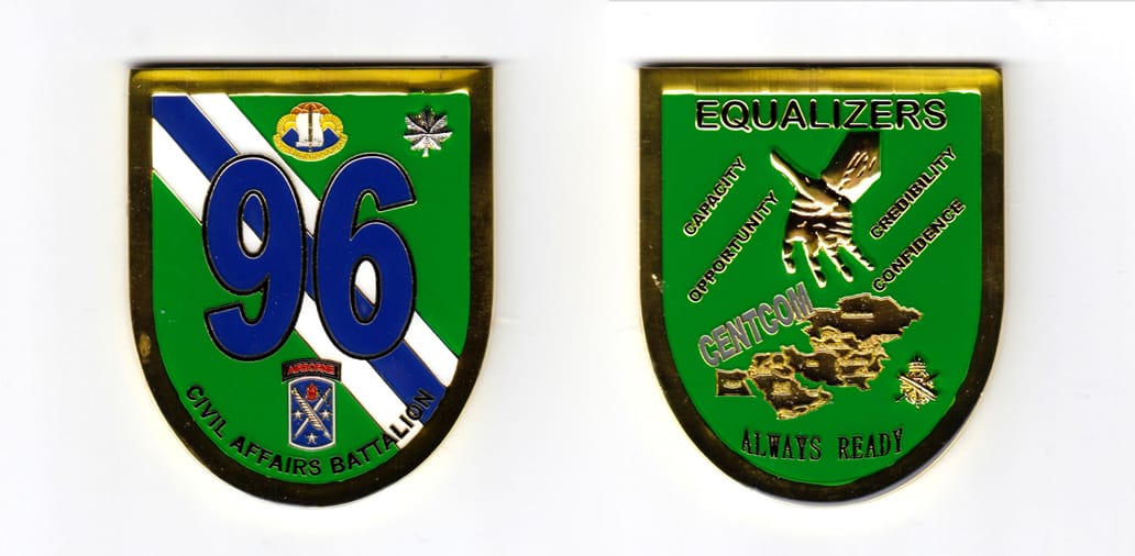 Shield shaped, gold colored coin, 2-1/4 inches wide x 3 inches high.