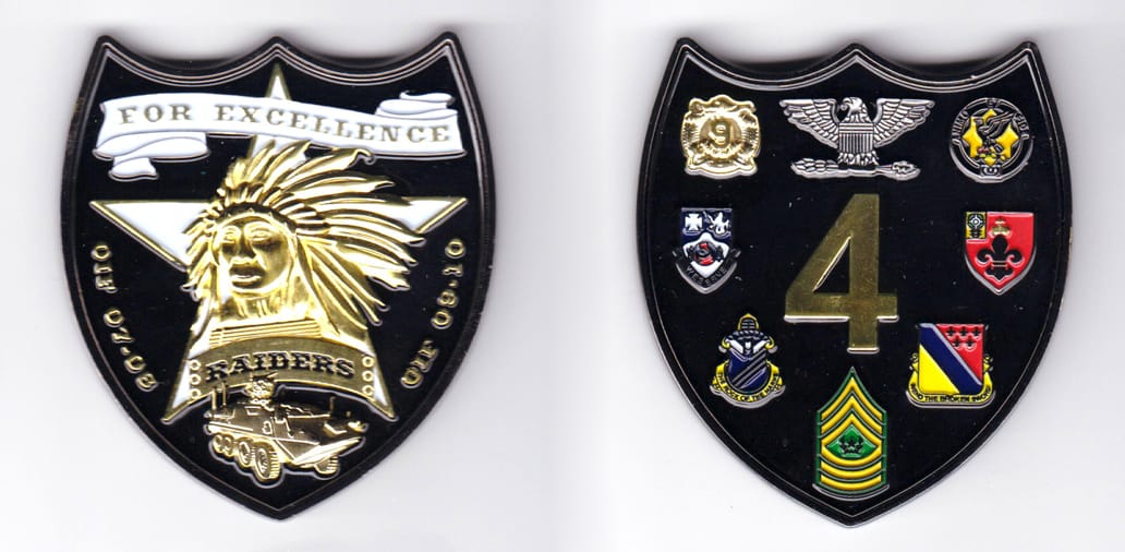 Shield shaped, gun metal black colored coin, 2-1/4 inches wide x 2-1/2 inches high.