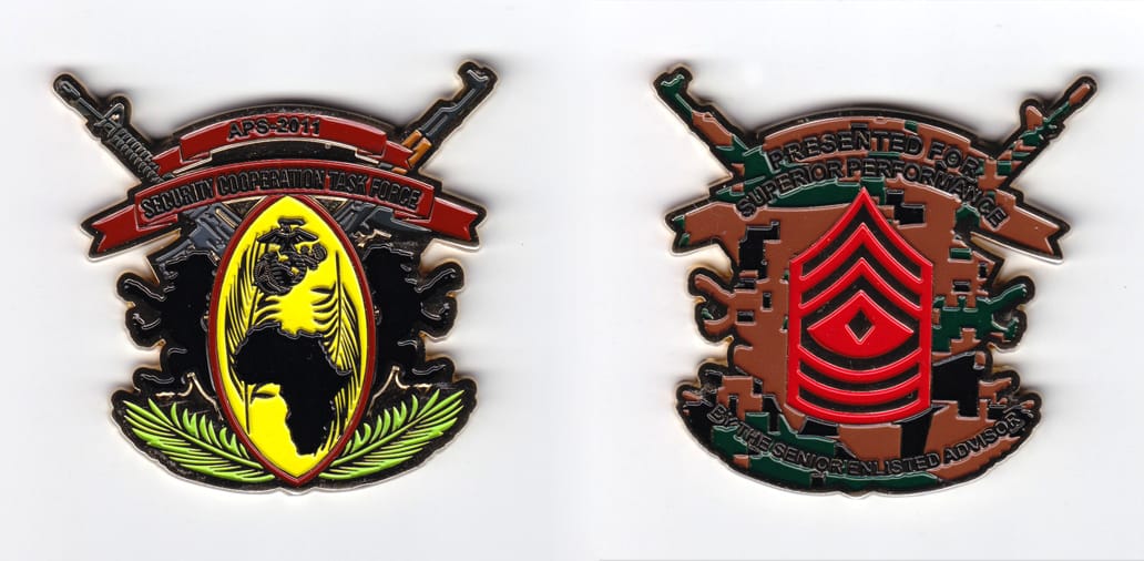 Gold colored coin, 2-3/16 inches wide x 2-1/2 inches high.