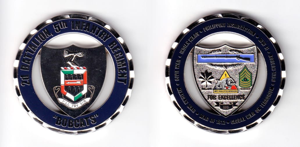 Round shaped, silver colored coin, 2 inches in diameter.