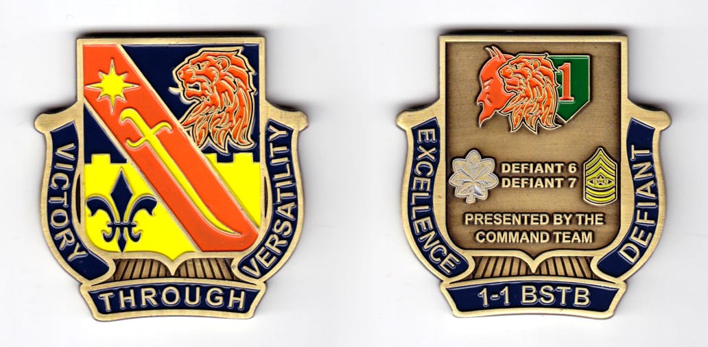 Shield shaped, with banner mounted on sides and beneath, brass colored coin, 2 inches high x 2  inches wide.