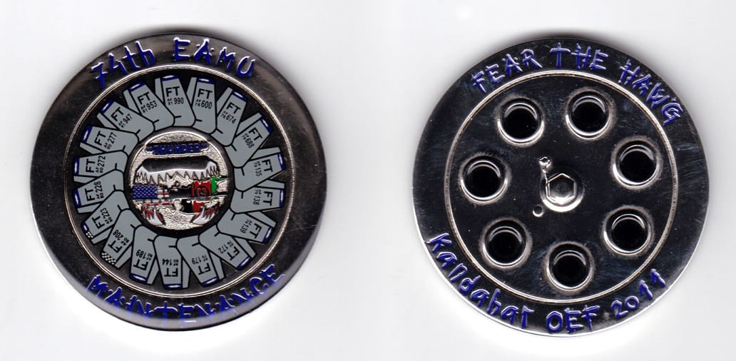 Round shaped, silver colored coin, 2 inches in diameter.