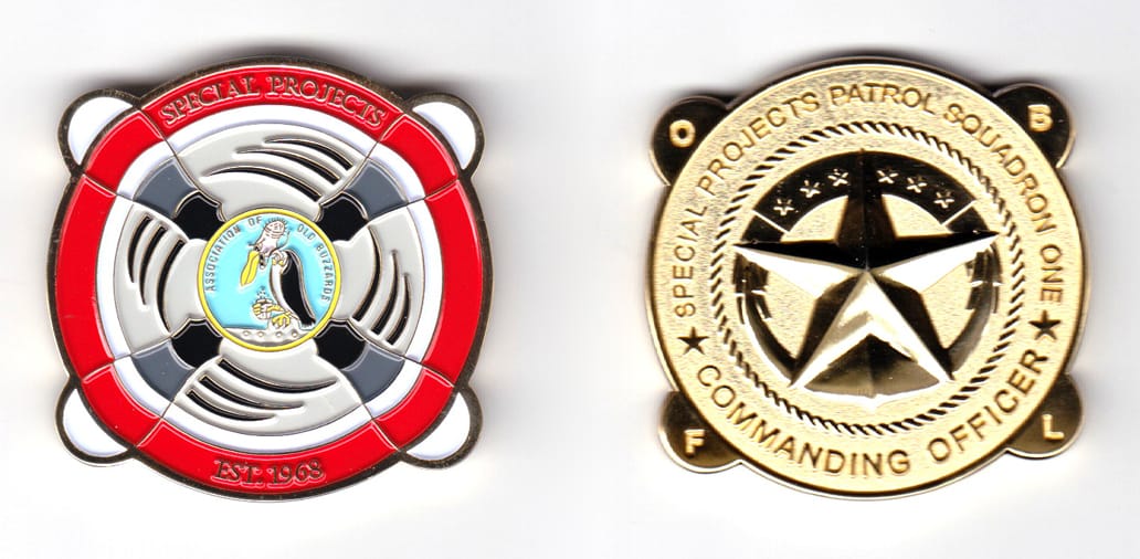 Round shaped, with 4 propeller blades extending, gold colored coin, 2 inches high x 2  inches wide.