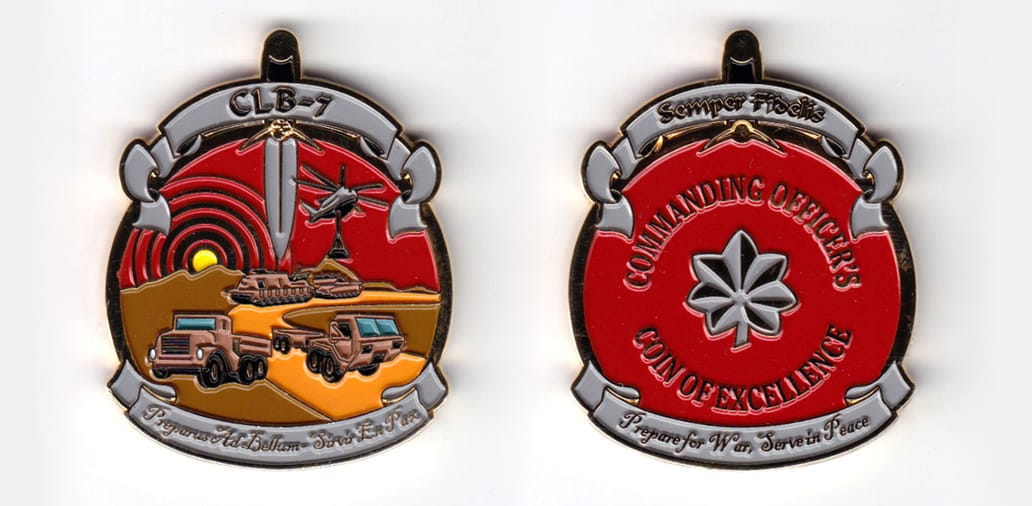 Round shaped, with banner mounted on above and beneath and daggar handle extending above, gold colored coin, 2 inches hi...